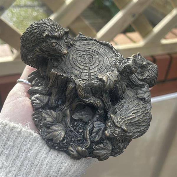Bronze tree stump with hedgehogs